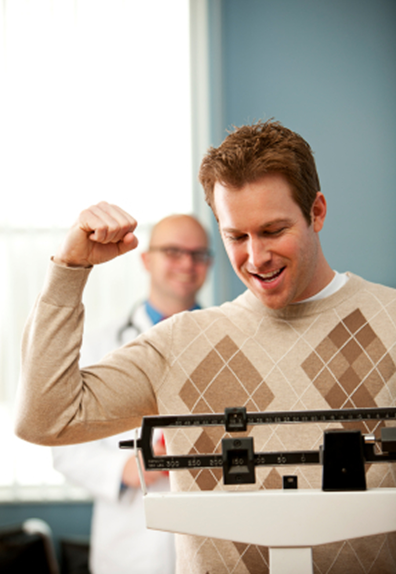 weight loss okotoks - happy guy on scale